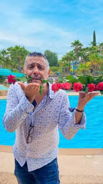 Jean-François of Esterel Caravaning, smiling with roses by the pool